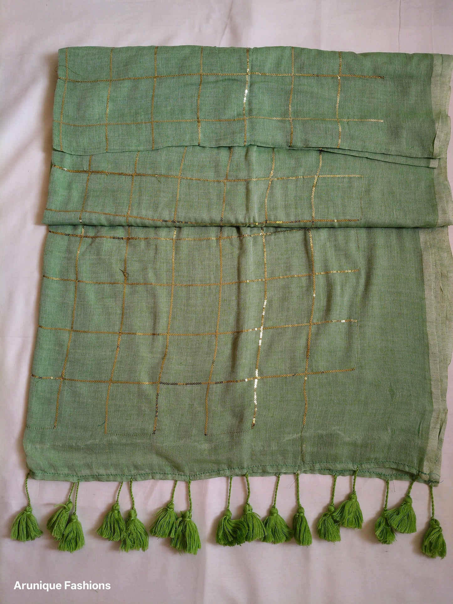 Trendy sage green sequin mul cotton saree - folded view showing fabric drape and texture