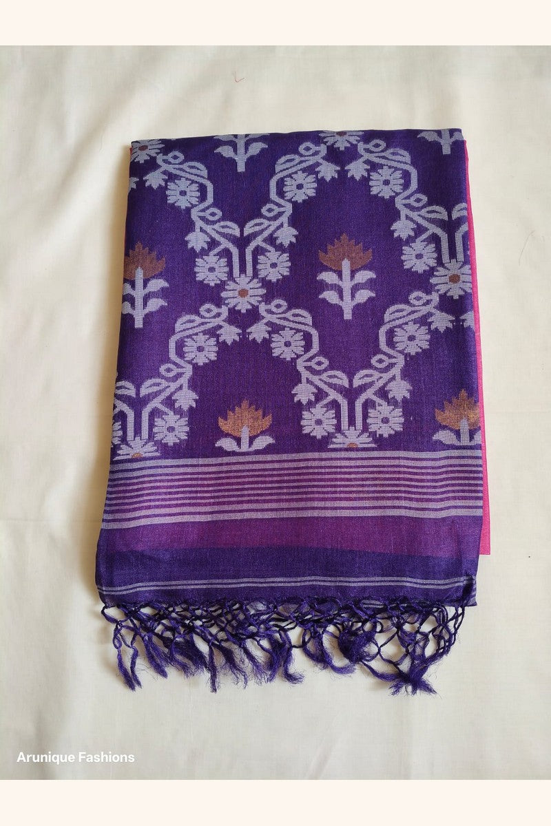 Folded Pure Tussar Silk Saree displaying royal purple ikat floral vine weave pallu with lavender-white motifs, golden tulip accents and navy knotted tassels