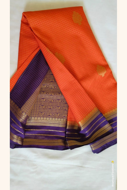 Royal purple pallu with dense geometric gold zari motifs – orange crepe silk saree – Arunique Fashions