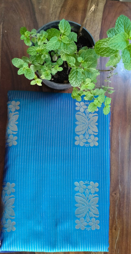 Turquoise Blue Saree with Golden Floral Butta & Purple Pink Zari Pallu - Saree Display on Table