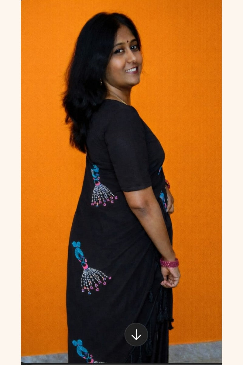 Model posing in black baby doll khadi saree with detailed motif design