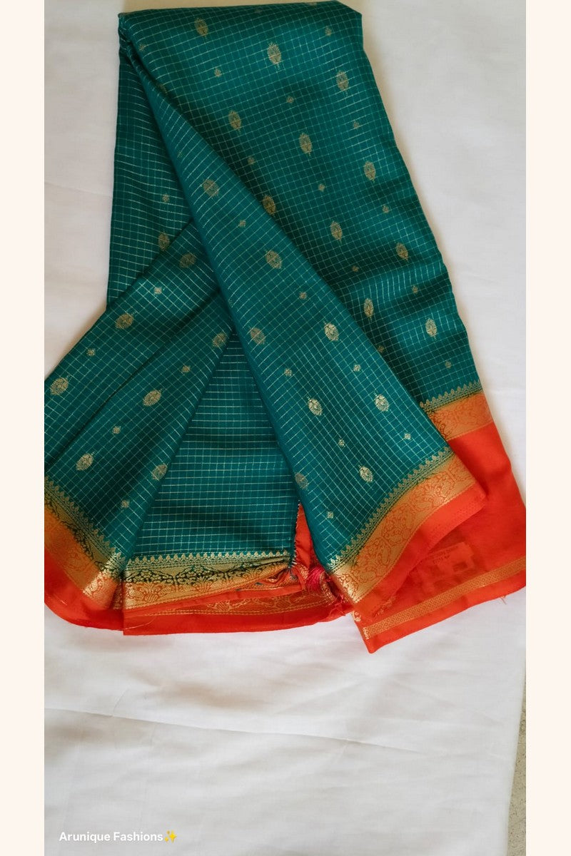 Rust orange blouse piece with gold zari border – bottle green crepe silk saree – Arunique Fashions