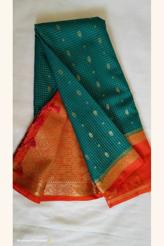 Rust orange pallu with dense floral golden zari motifs – bottle green crepe silk saree – Arunique Fashions