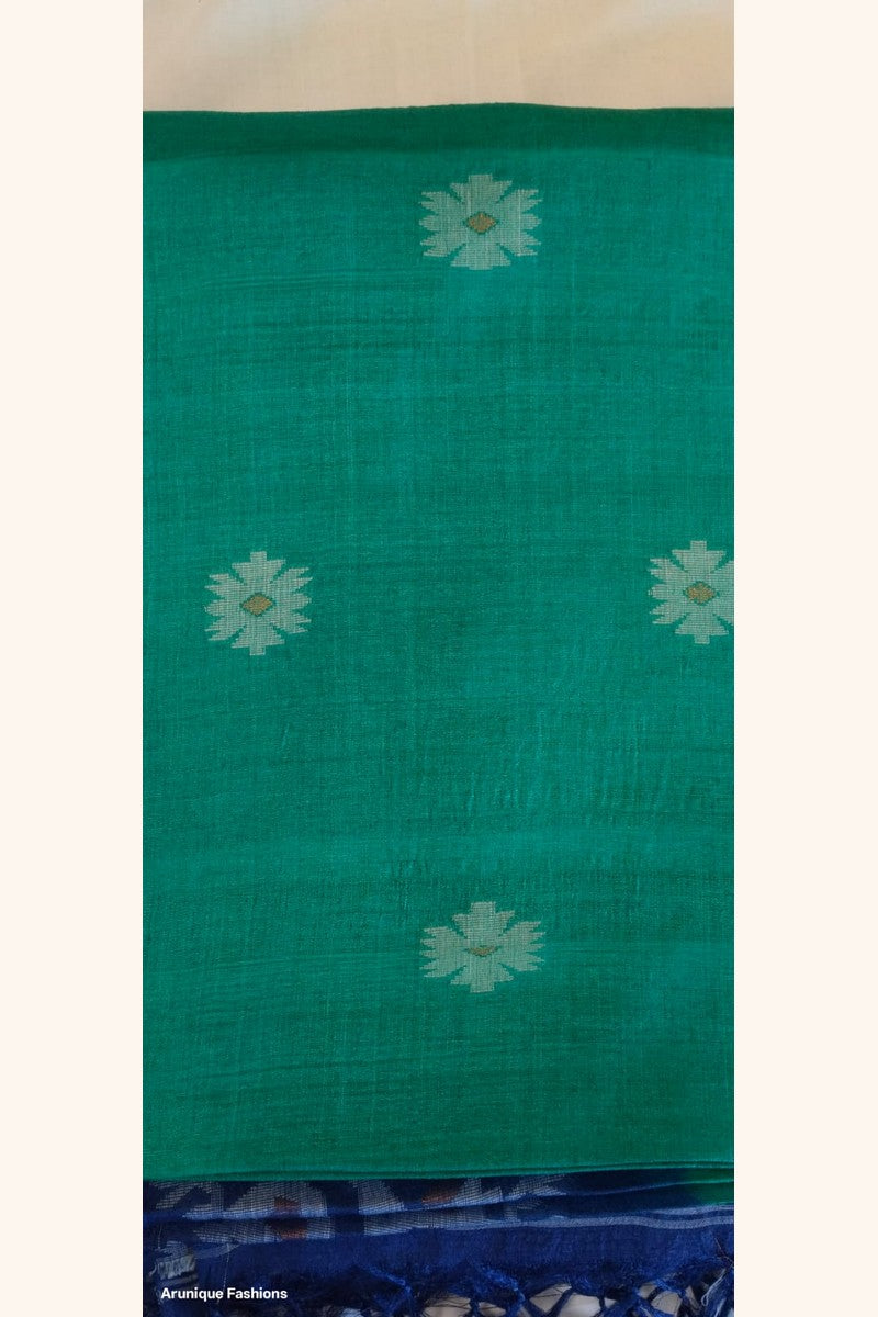Close-up of emerald green Pure Tussar Silk fabric with scattered silver geometric butti motifs