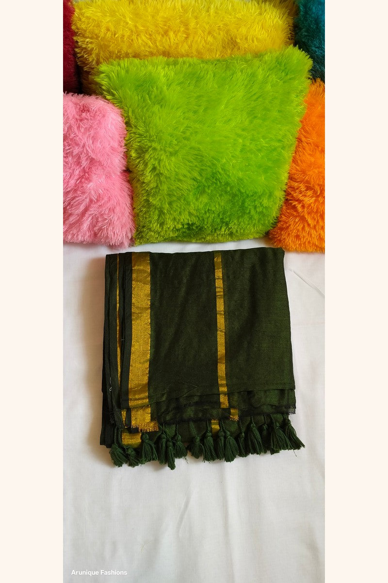 Close-up view of dark green double zari saree showing dual golden zari borders and tasseled pallu