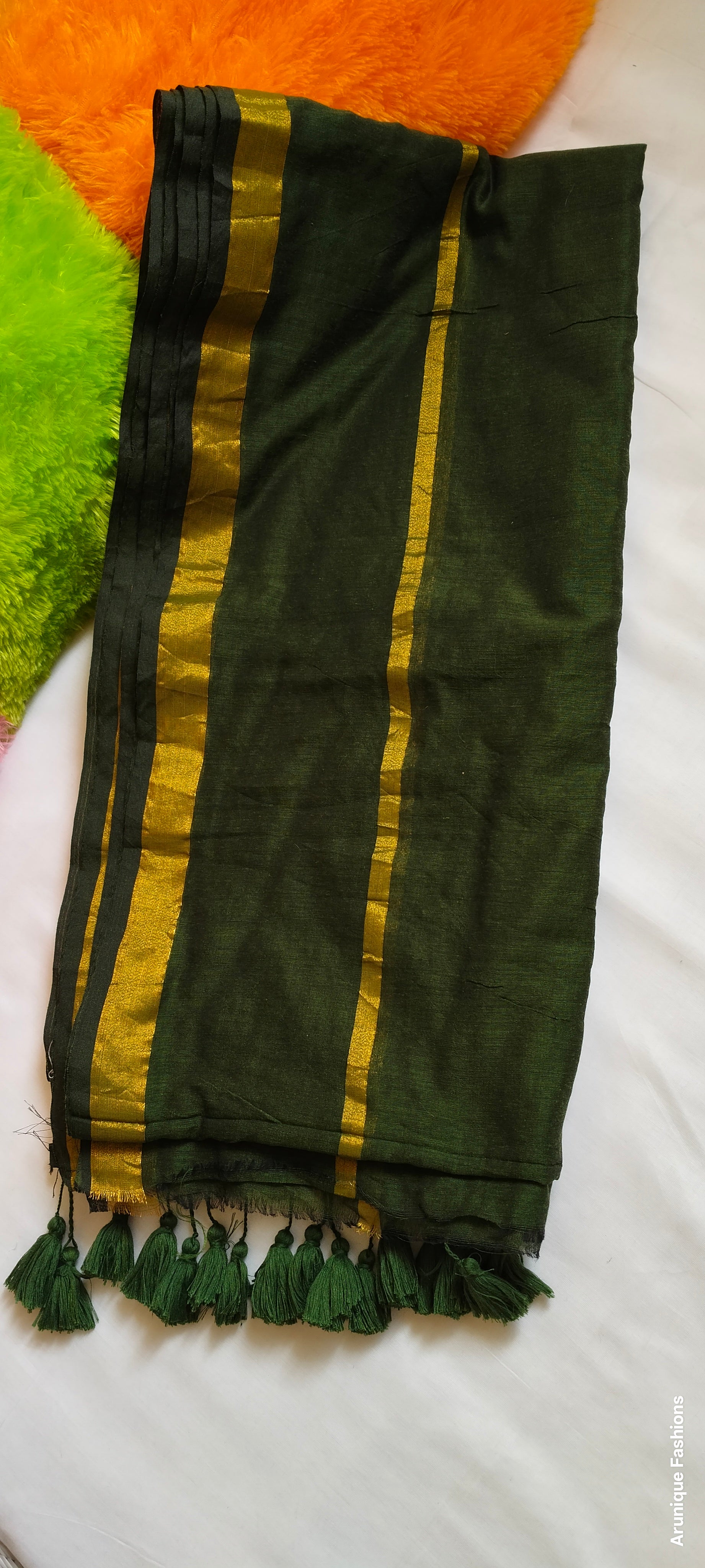 Enhanced view of dark green mul cotton saree with double golden zari borders and traditional tassels