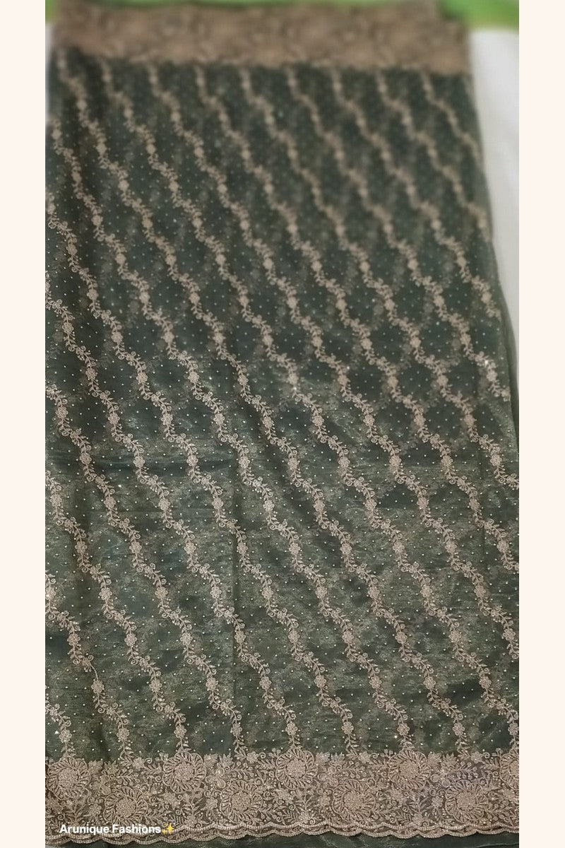 Dark olive green designer net saree - pallu with dense diagonal gold zari floral vine embroidery and stone embellishments