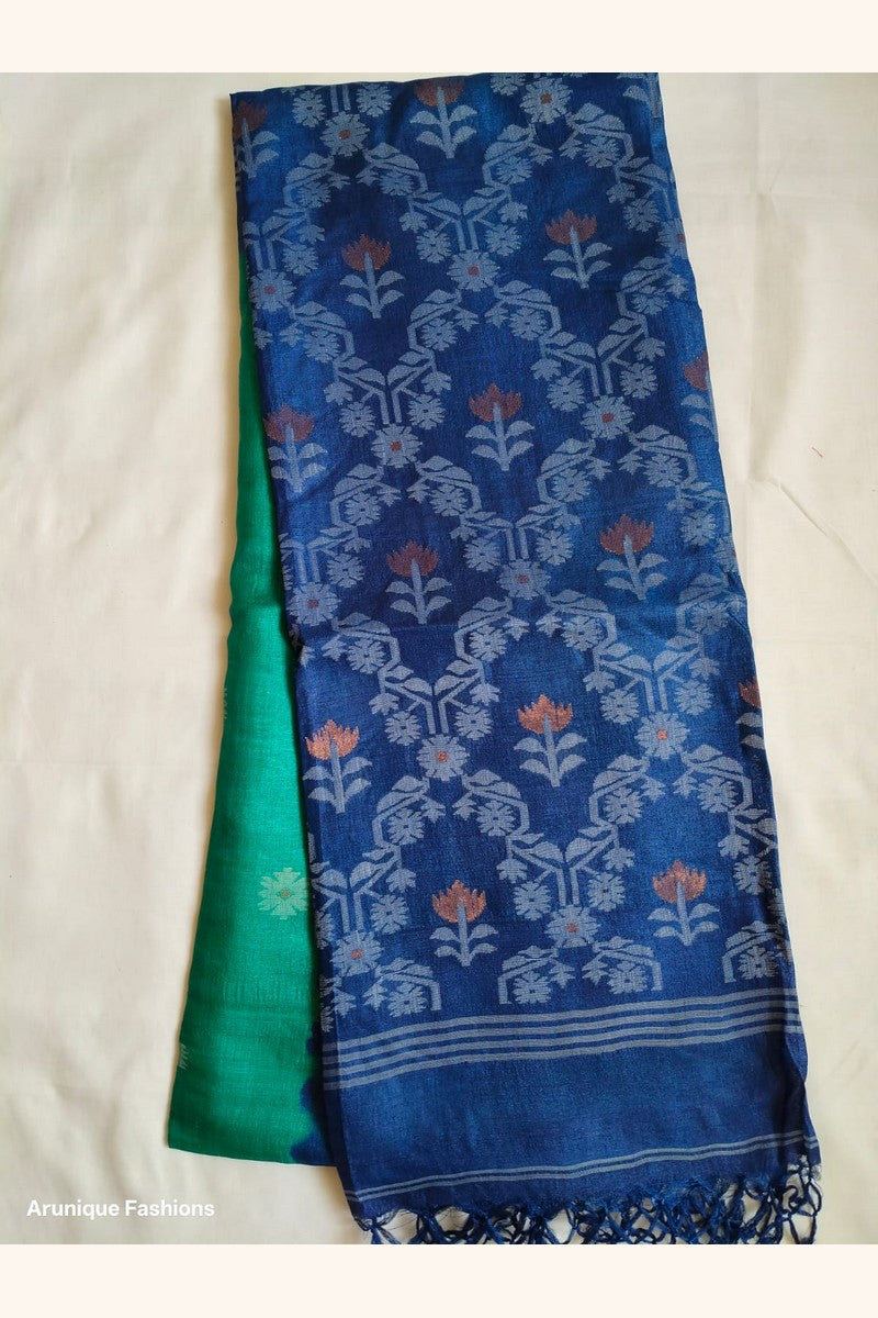Pure Tussar Silk Saree displayed showing emerald green body with silver geometric butti motifs and navy blue ikat pallu