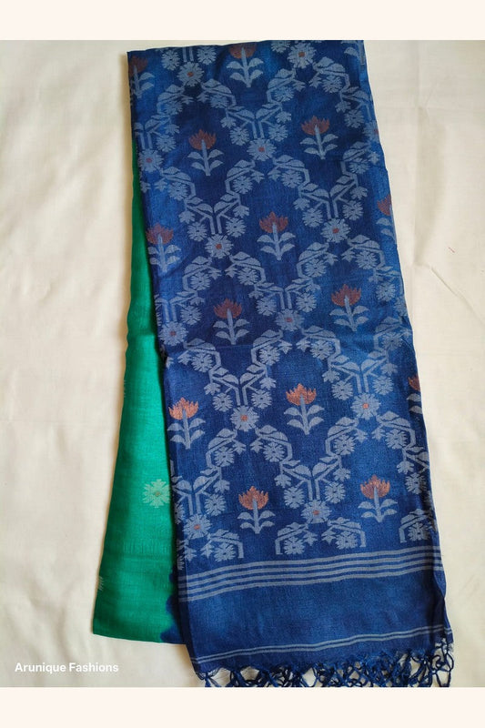 Pure Tussar Silk Saree displayed showing emerald green body with silver geometric butti motifs and navy blue ikat pallu