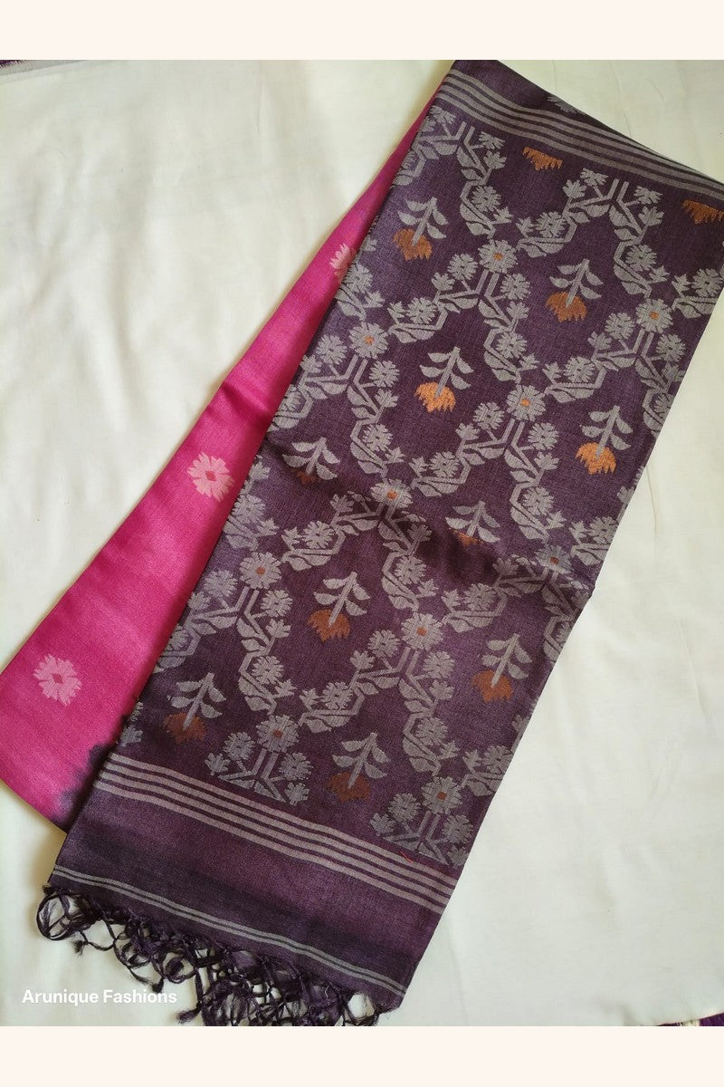 Flat lay of Pure Tussar Silk Saree showing deep plum ikat floral pallu alongside hot pink body with daisy butti motifs