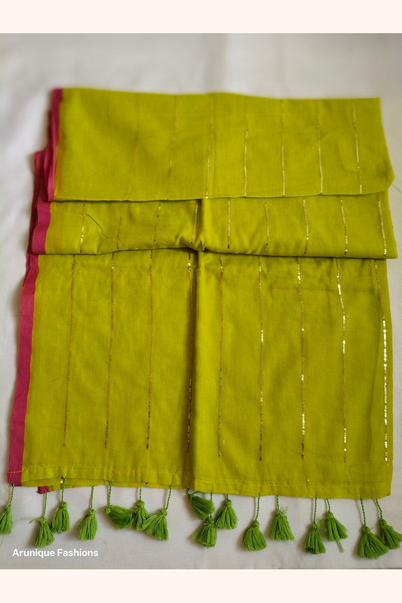 Trendy lime yellow sequin mul cotton saree - folded view showing pink border and green tassels