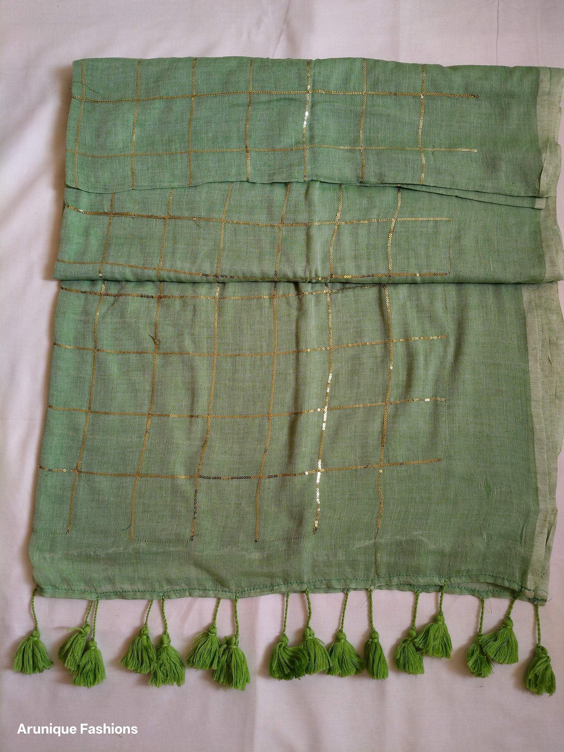 Trendy sage green sequin mul cotton saree - folded view showing fabric drape and texture