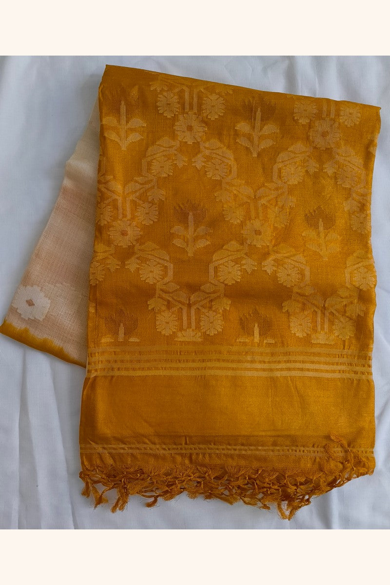 Folded Pure Tussar Silk Saree showing cream body with self-woven floral butti motifs and mustard gold ikat border with tassels
