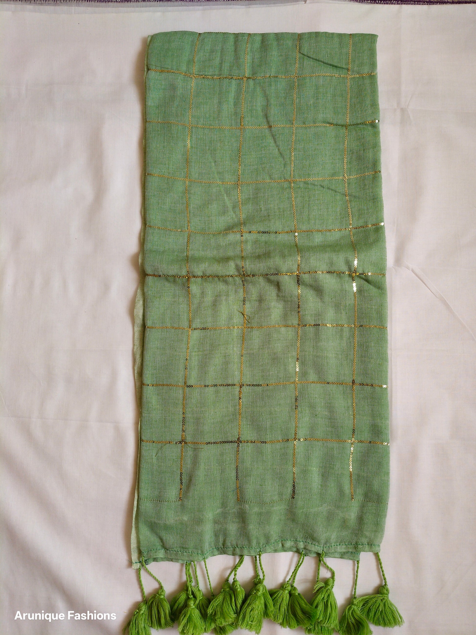 Sage green mul cotton saree with golden sequins - full pallu view with green tassels
