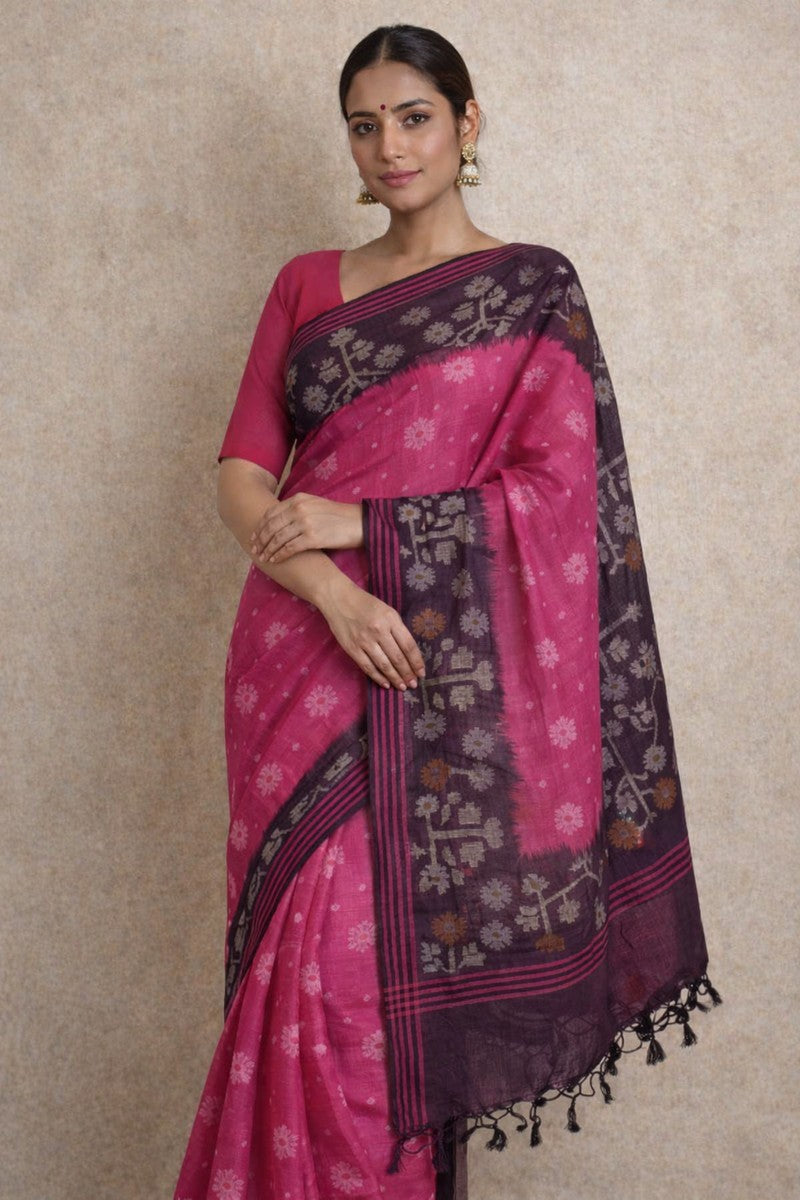 Indian woman draped in hot pink Pure Tussar Silk Saree with deep plum ikat floral tree weave border and pallu