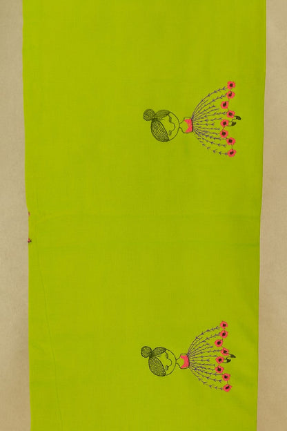 Close-up of embroidered baby doll motif fabric texture on lime green khadi