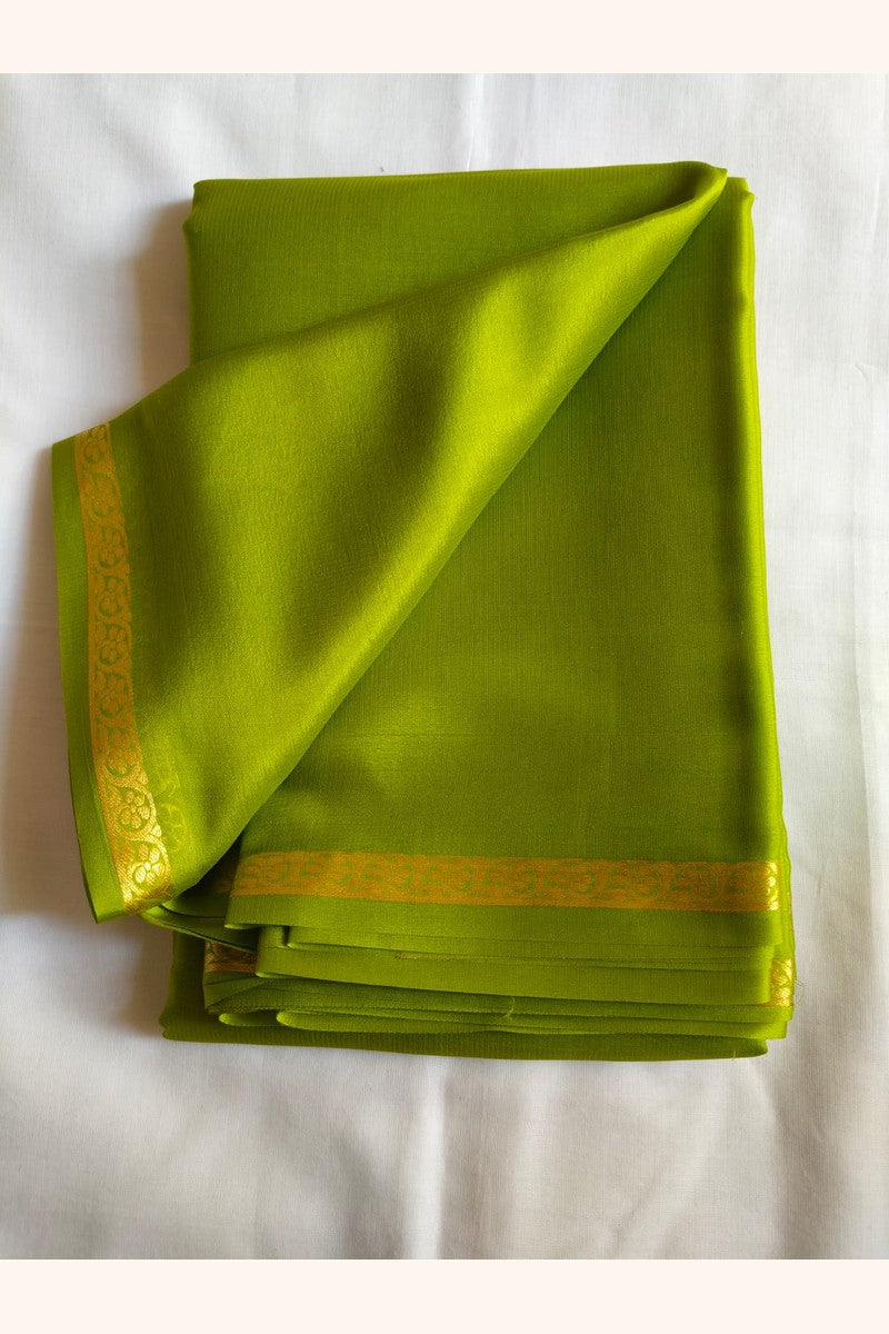 Close-up of the golden half-inch floral zari border on a lime green Pure Mysore Silk saree