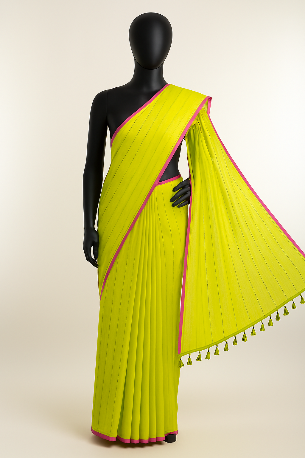 Lime yellow sequin mul cotton saree with pink border displayed on black mannequin - full drape view