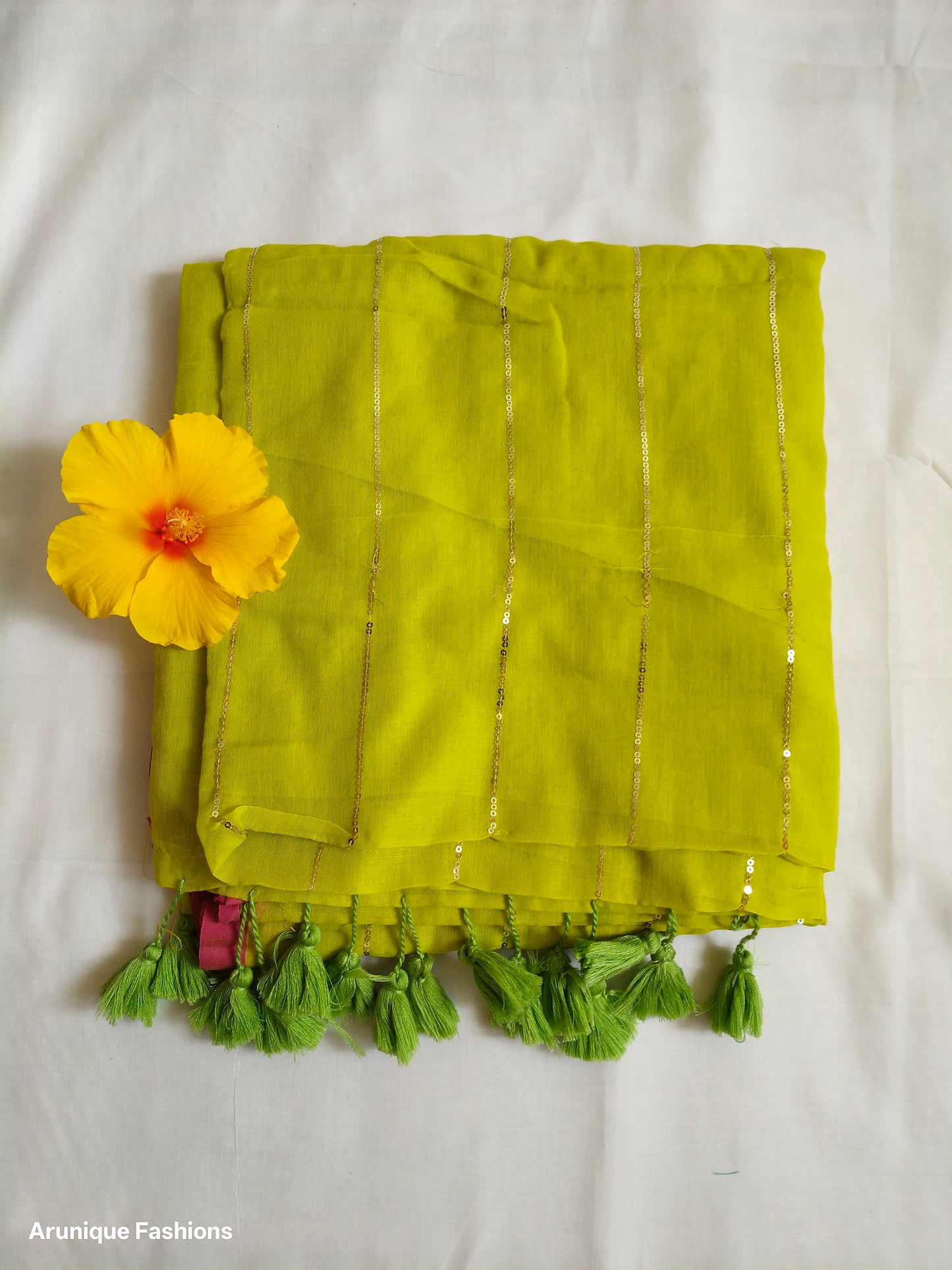 Lime yellow mul cotton saree with vertical golden sequins - fabric texture detail with decorative flower