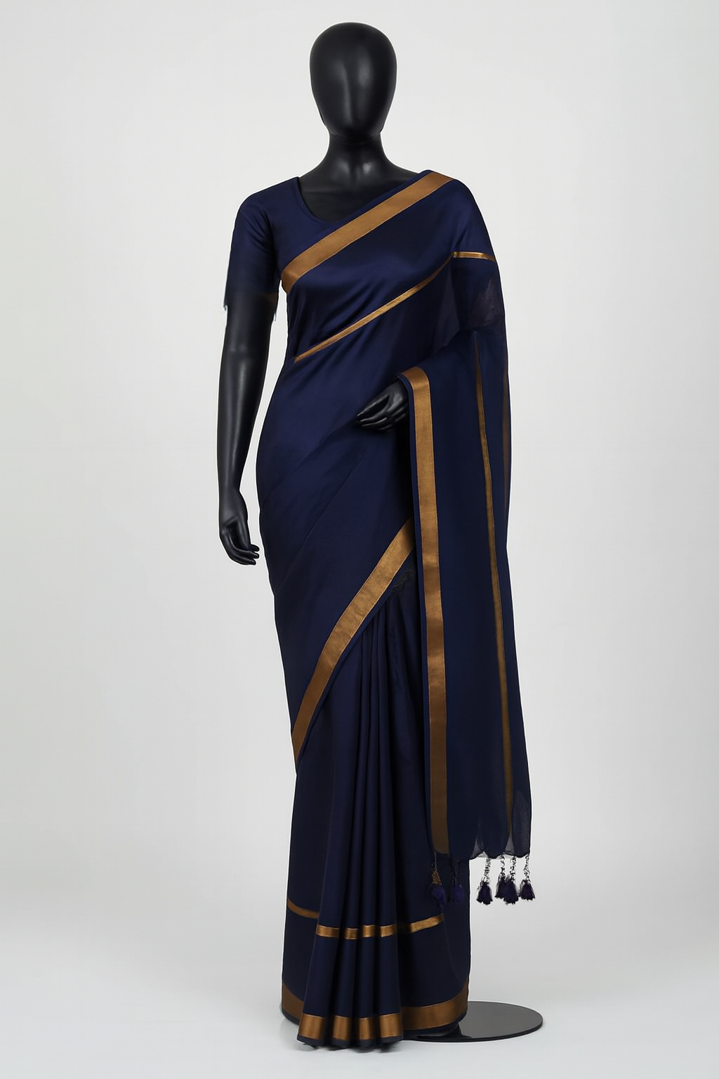 Navy blue double zari mul cotton saree displayed on mannequin showing elegant drape with dual golden borders
