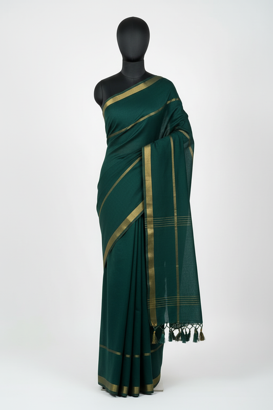 Dark green double zari mul cotton saree displayed on mannequin showing elegant drape with dual golden borders