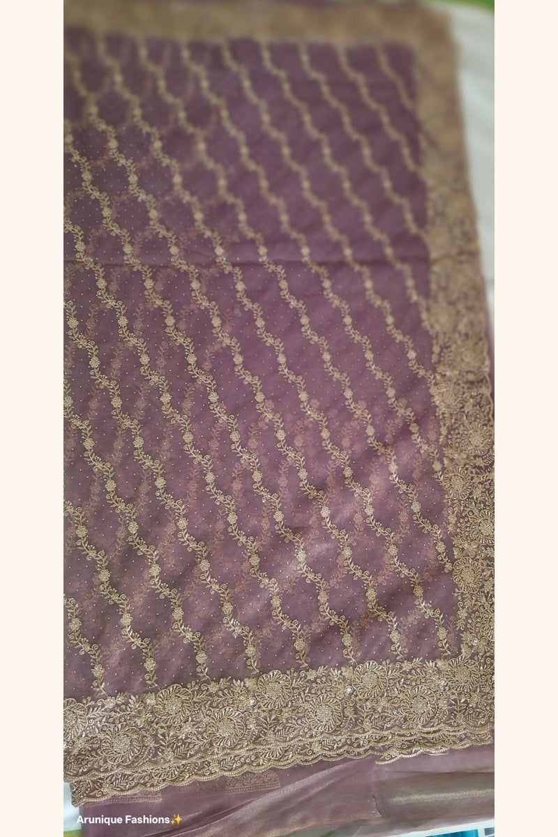 Mauve premium designer net saree - flat lay showing diagonal gold zari floral vine embroidery rows and scalloped border