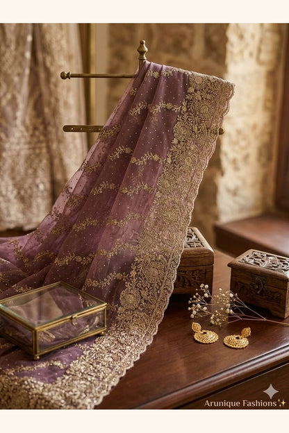 Mauve premium designer net saree - styled drape showing diagonal gold zari embroidery and scalloped border