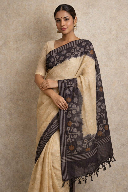 Indian woman model wearing Pure Tussar Silk Saree in cream body with charcoal black ikat border and pallu