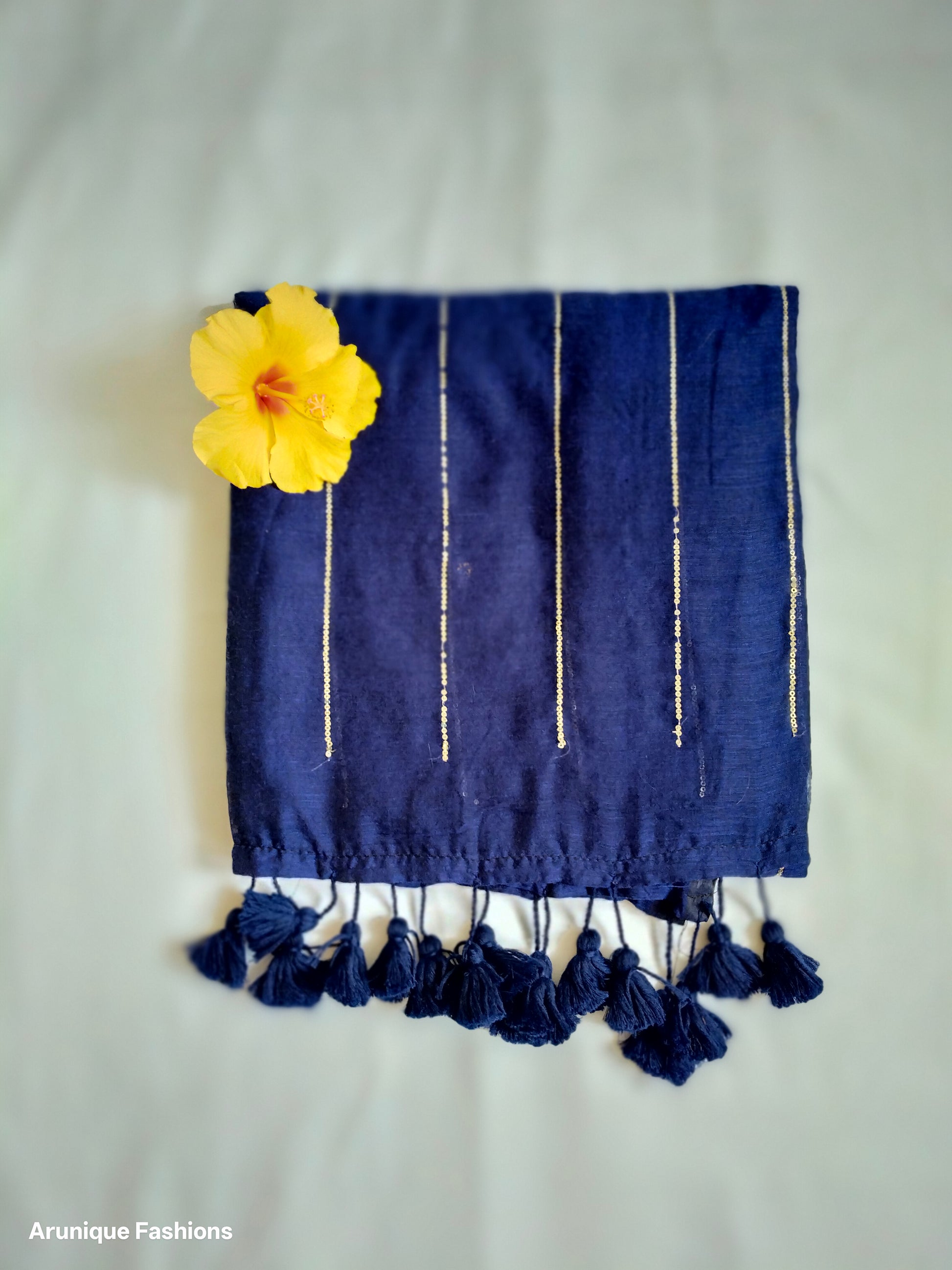 Navy blue mul cotton saree with vertical golden sequins - fabric texture detail with decorative flower