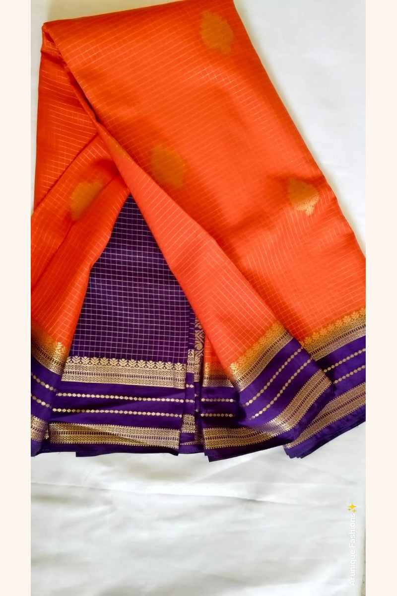 Royal purple blouse piece with gold zari border – orange crepe silk saree – Arunique Fashions