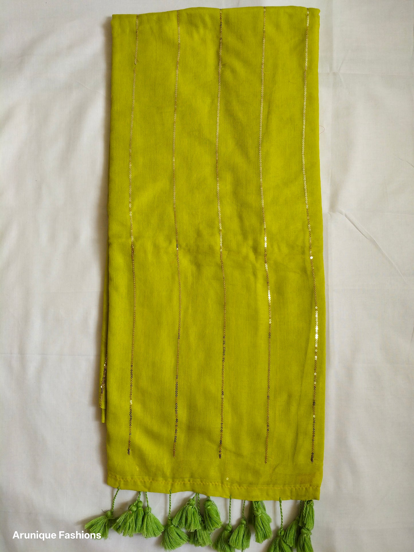 Lime yellow mul cotton saree with vertical sequin work - full pallu view with green tassels