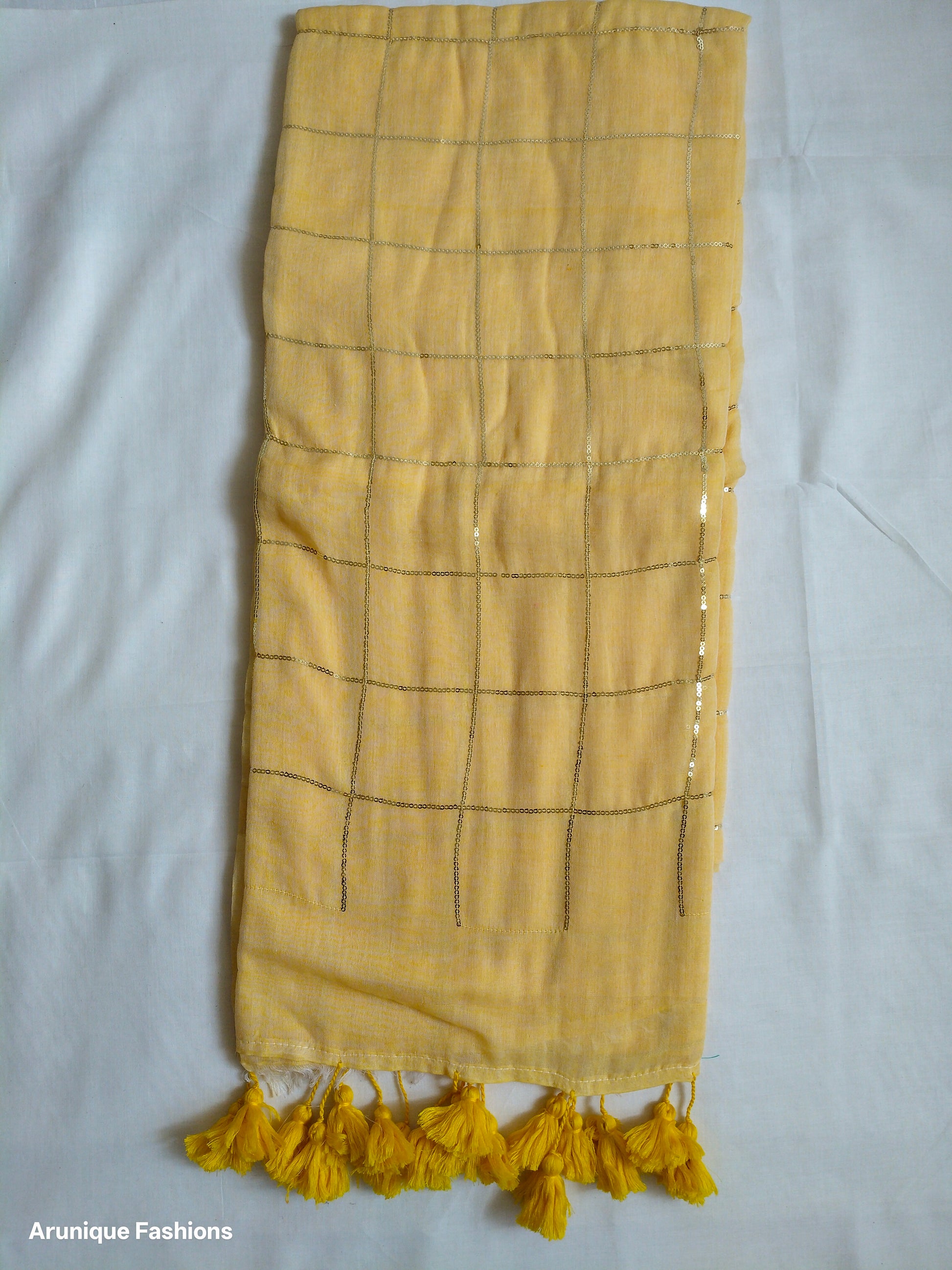 Trendy soft pastel yellow sequin mul cotton saree - full view with yellow tassels and grid pattern