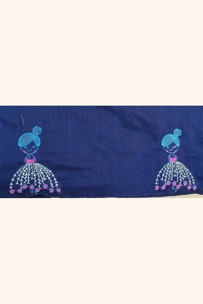 Close-up of embroidered baby doll motif fabric texture on royal blue khadi