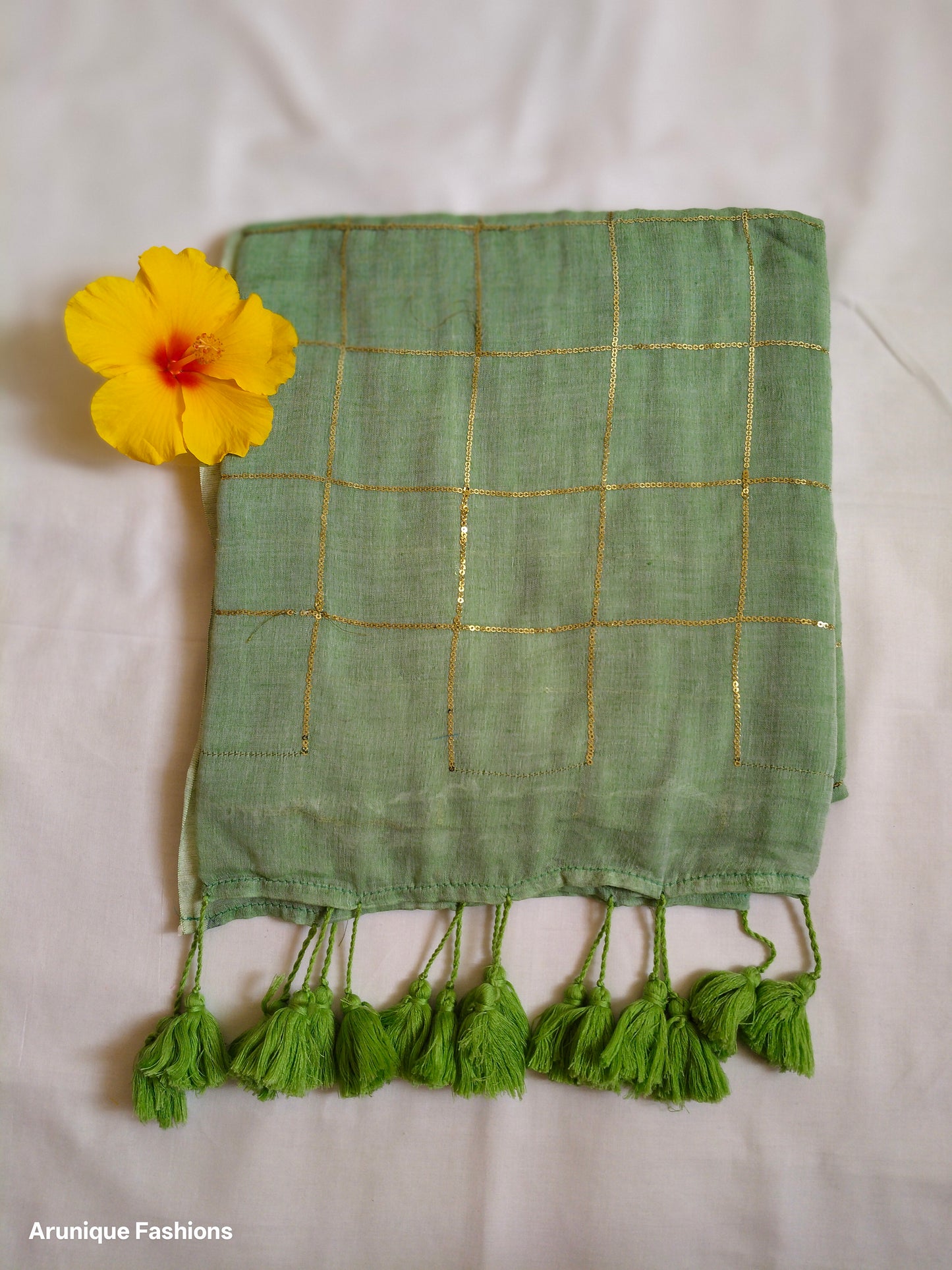 Sage green mul cotton saree with sequin embellishment - fabric detail with decorative flower