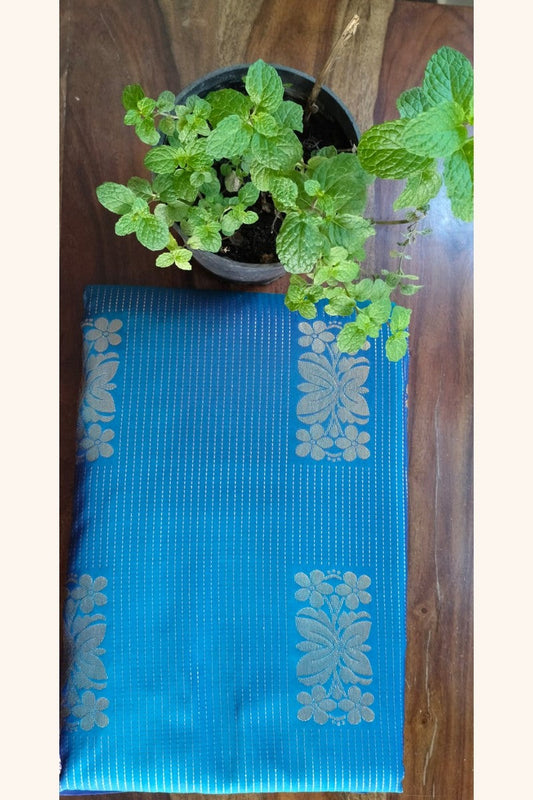 Turquoise Blue Saree with Golden Floral Butta & Purple Pink Zari Pallu - Saree Display on Table