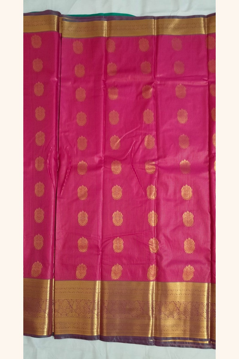 Close-up of gold diamond butta motifs on vibrant pink semi-silk body